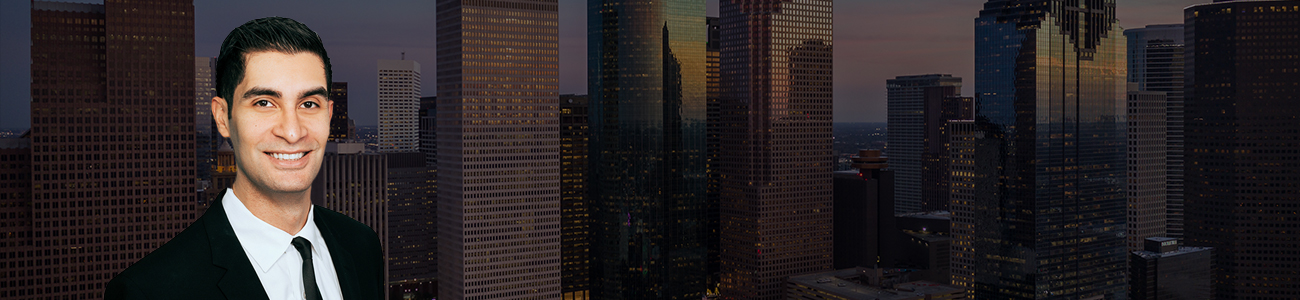 Armand Jawanmardi with a photograph of the Houston skyline with a dark filter.