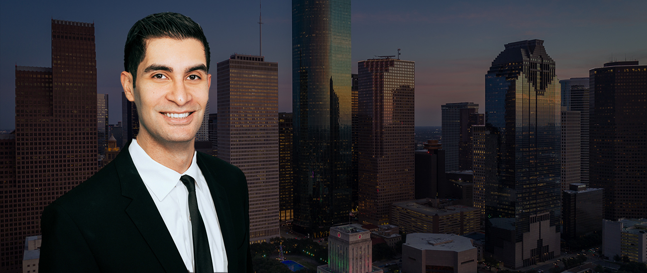 Armand Jawanmardi with a photograph of the Houston skyline with a dark filter.